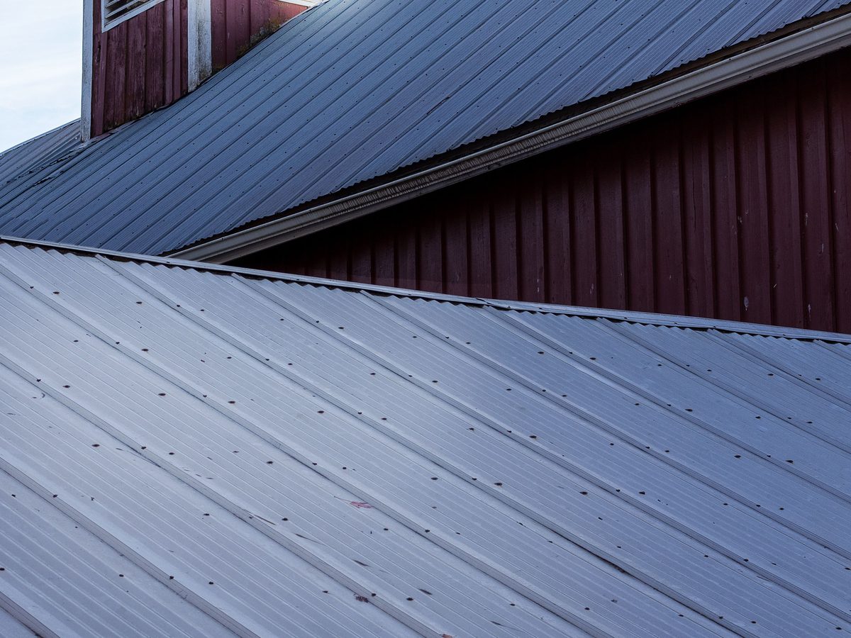 Commercial standing-seam metal roof panels installed by Shield Proof Roofing